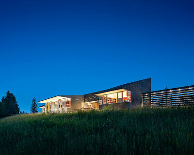stillwater residence emerges as a series of farm sheds within verdant veil of montana