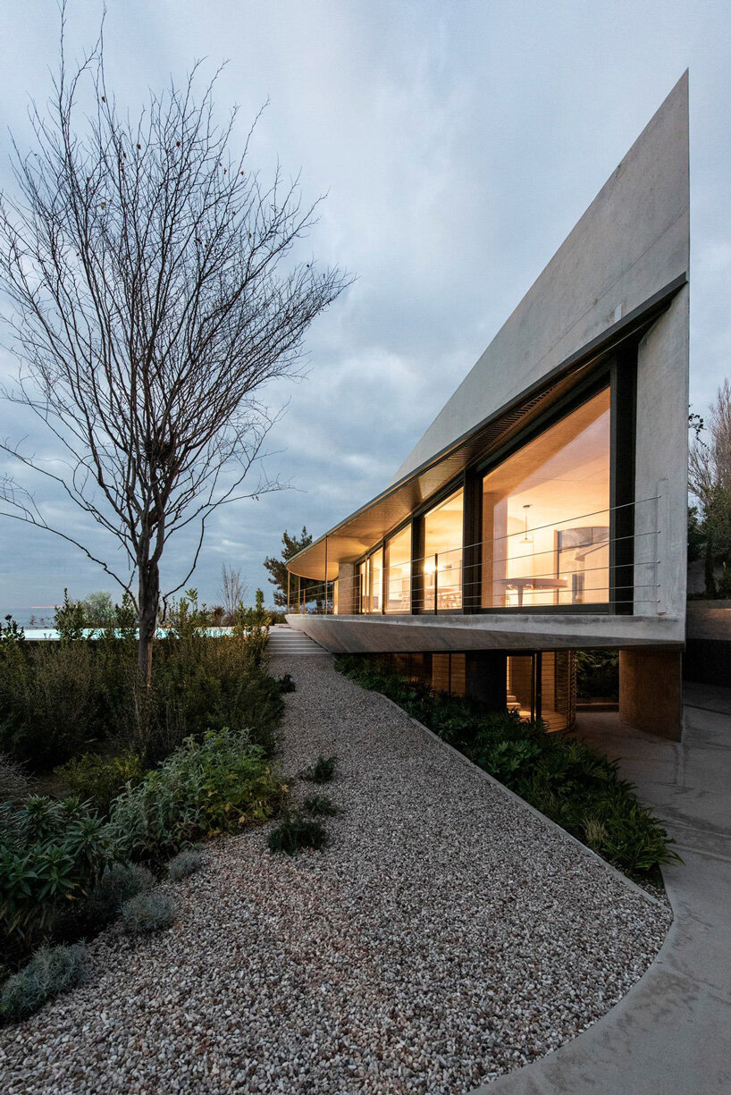 tense architecture network adds circular pool to concrete island residence in greece