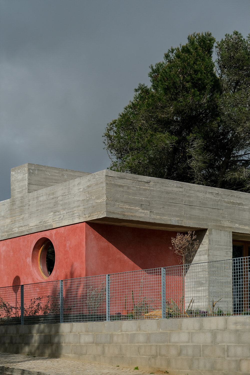 pink 'untitled' concrete house unfolds in the portuguese landscape
