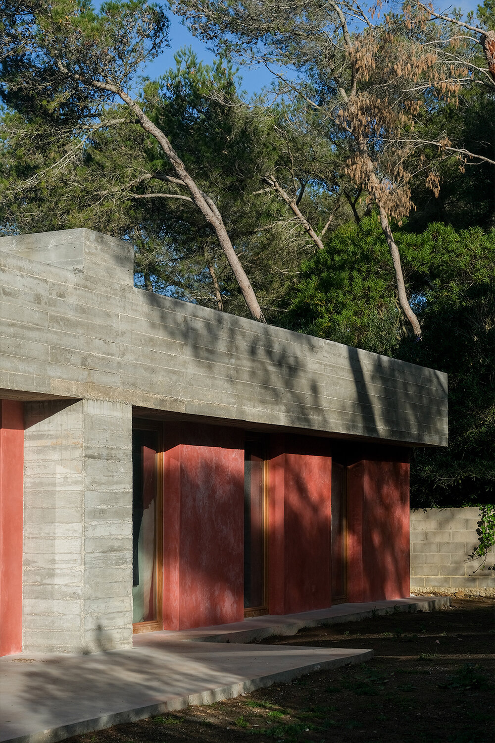 pink 'untitled' concrete house emerges from portuguese landscape