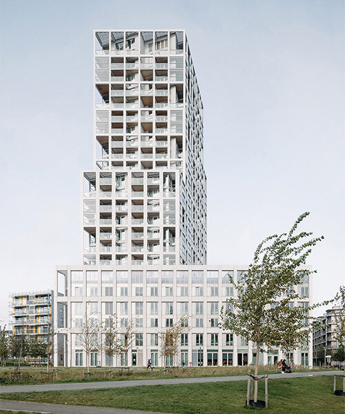 staggered white high-rise provides diverse adaptable housing in antwerp, belgium
