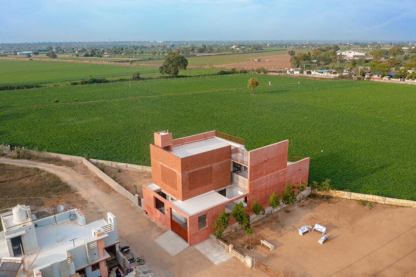 brick perforations and diverse cutouts characterize family house in india