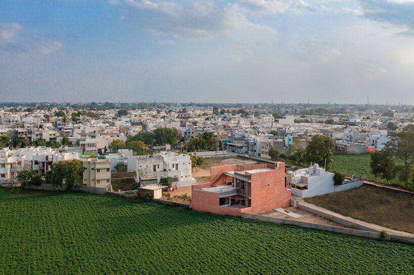 brick perforations and diverse cutouts characterize family house in india