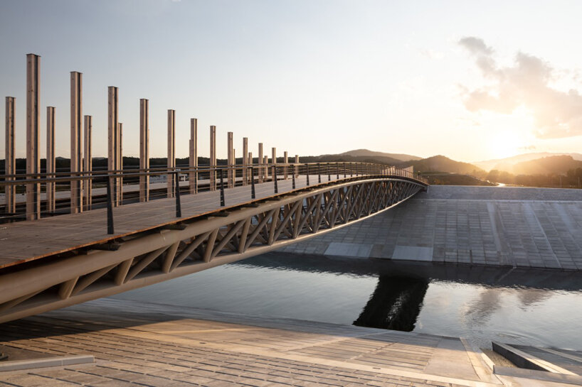 kengo kuma shapes gently arched bridge for recovering tsunami-hit town