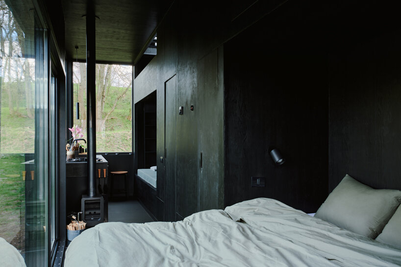 sigurd larsen makes nature the protagonist with muted black cabin retreat