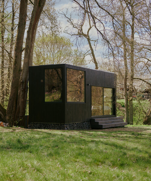 sigurd larsen makes nature the protagonist with muted black cabin retreat