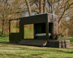 sigurd larsen makes nature the protagonist with muted black cabin retreat