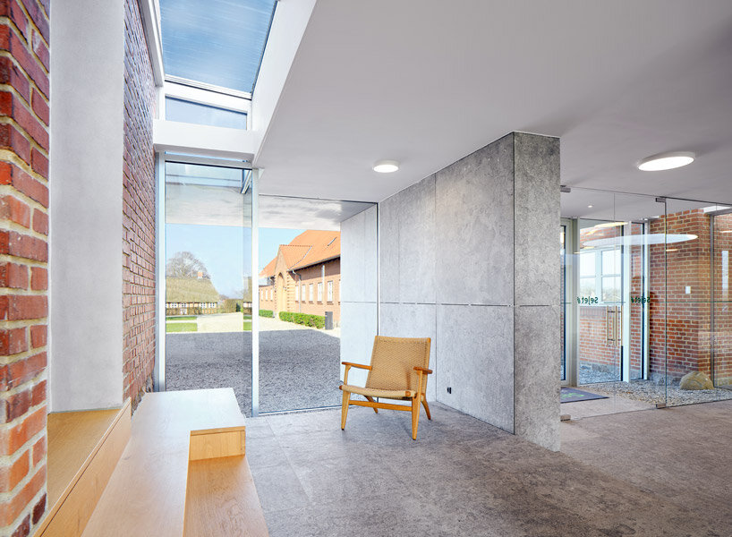 natural stone, oak wood, and textured paint transform this traditional farm in denmark