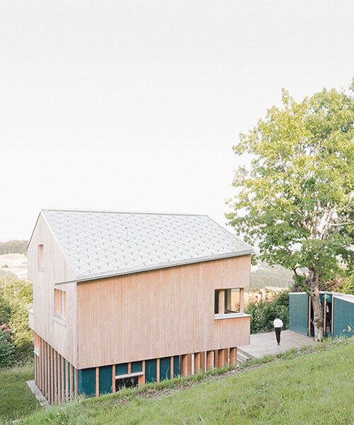 studio yonder weaves timber house with sauna hut into the mountains of germany