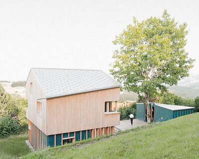 studio yonder weaves timber house with sauna hut into the mountains of germany