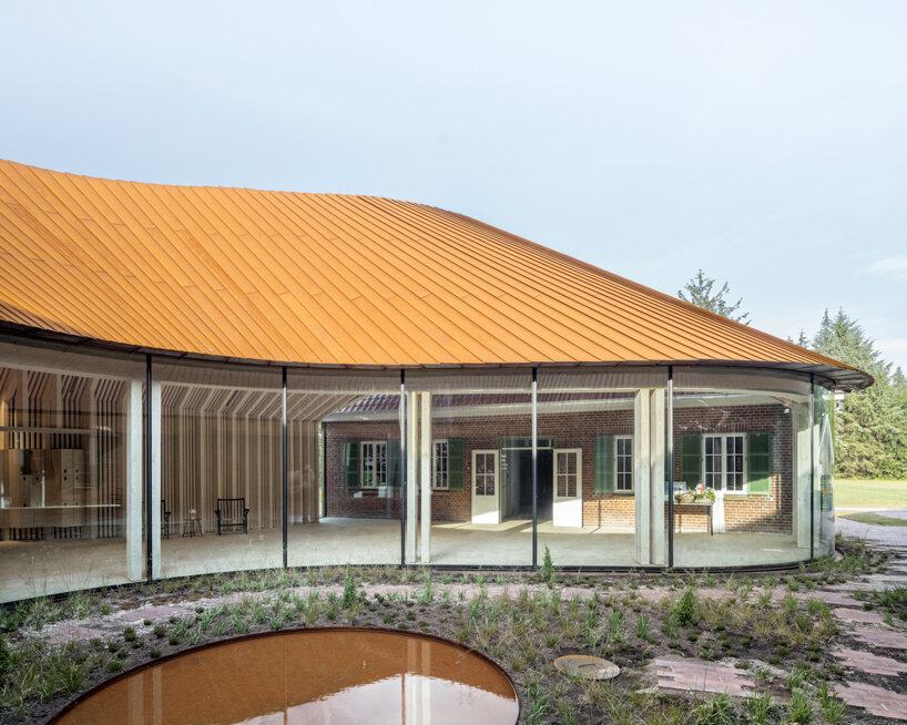 BIG adds a curved corten steel corner to new refugee museum of denmark