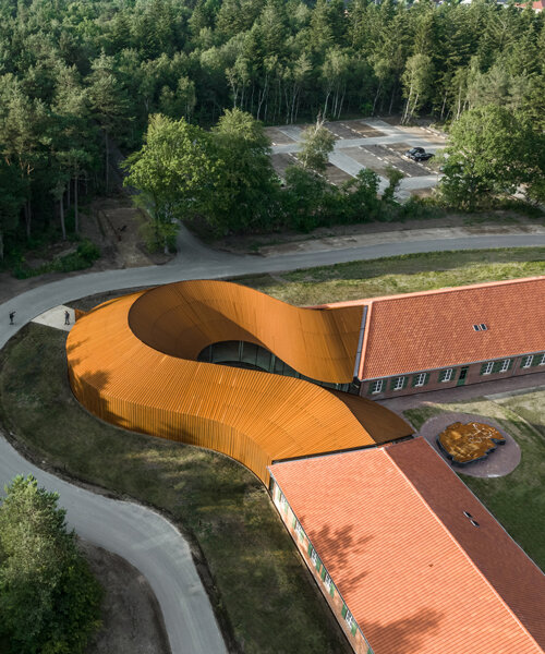 BIG adds a curved corten steel volume to new refugee museum of denmark