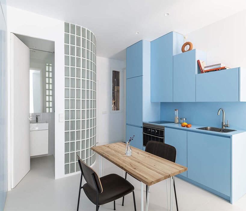 curved glass partitions and light blue tones enhance this renovated house in madrid