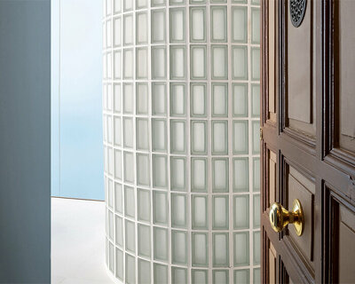 curved glass partitions and light blue tones uplift this renovated house in madrid