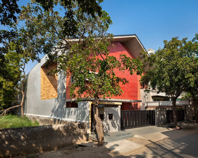 anagram architects infuses the red concrete house in india with a whimsical play