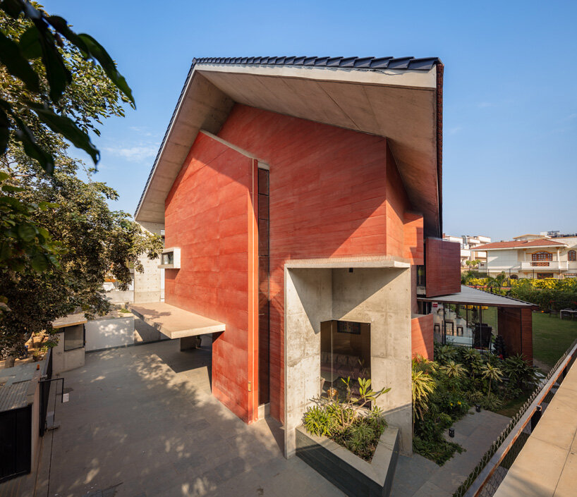 anagram architects infuses red concrete house in india with whimsical playfulness