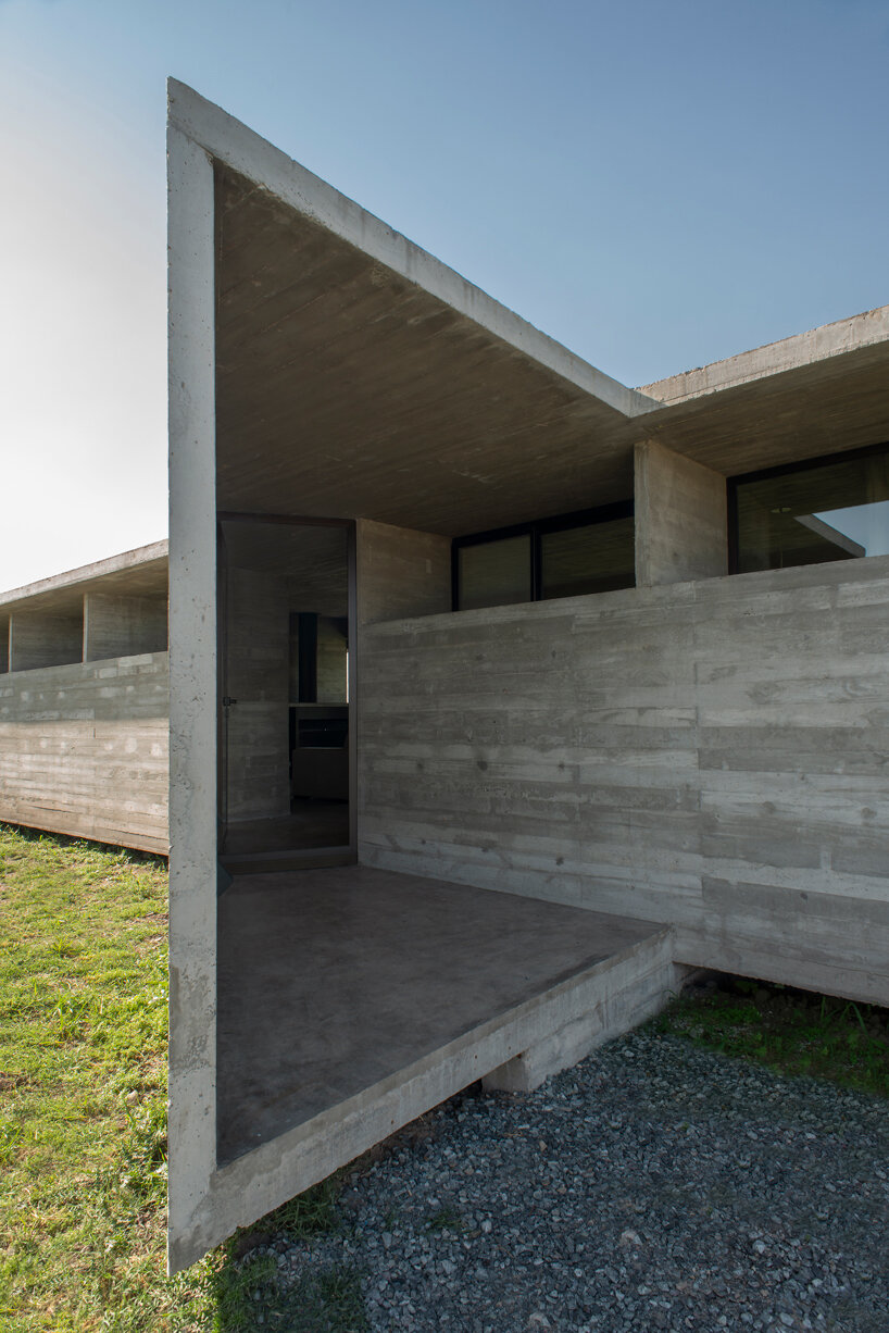 luciano kruk shapes one long concrete volume for 'countryside house' in argentina