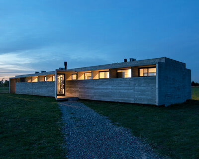 luciano kruk shapes one long concrete volume for 'countryside house' in argentina