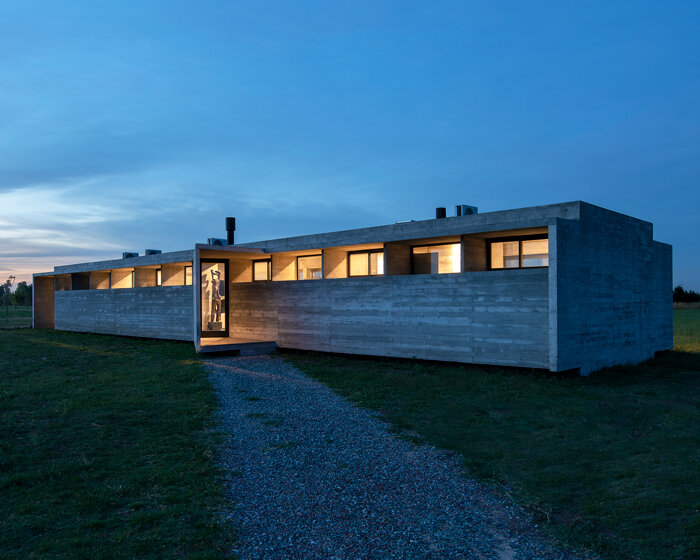 luciano kruk shapes one long concrete volume for 'countryside house' in argentina