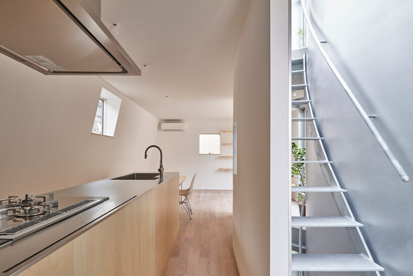 curved metal staircase slices through 'scoop landscape house' in tokyo