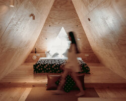 wiki world tops wooden cabin in suburban wuhan with snug, triangular loft