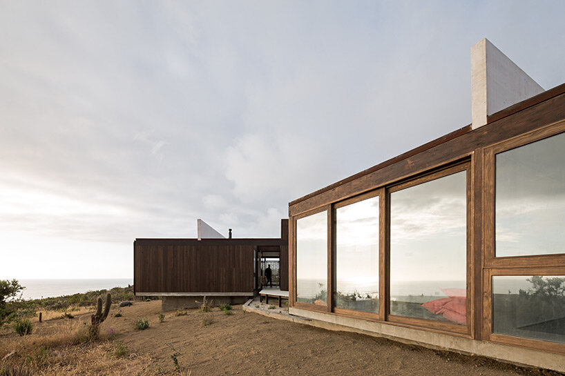 beach house by juan pablo ureta takes cues from rock clusters in chilean natural landscape