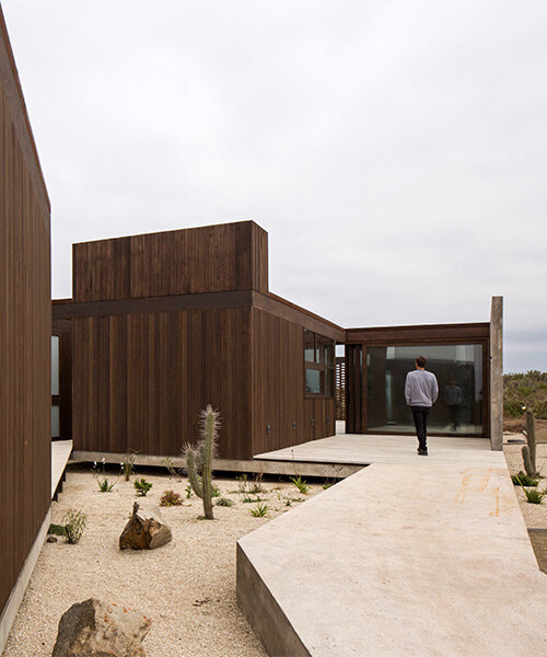 beach house by juan pablo ureta takes cues from rock clusters in chilean natural landscape