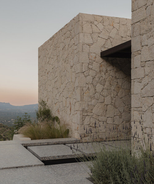 block722's 'hill house' is a cluster of stone volumes among the wild landscape of crete