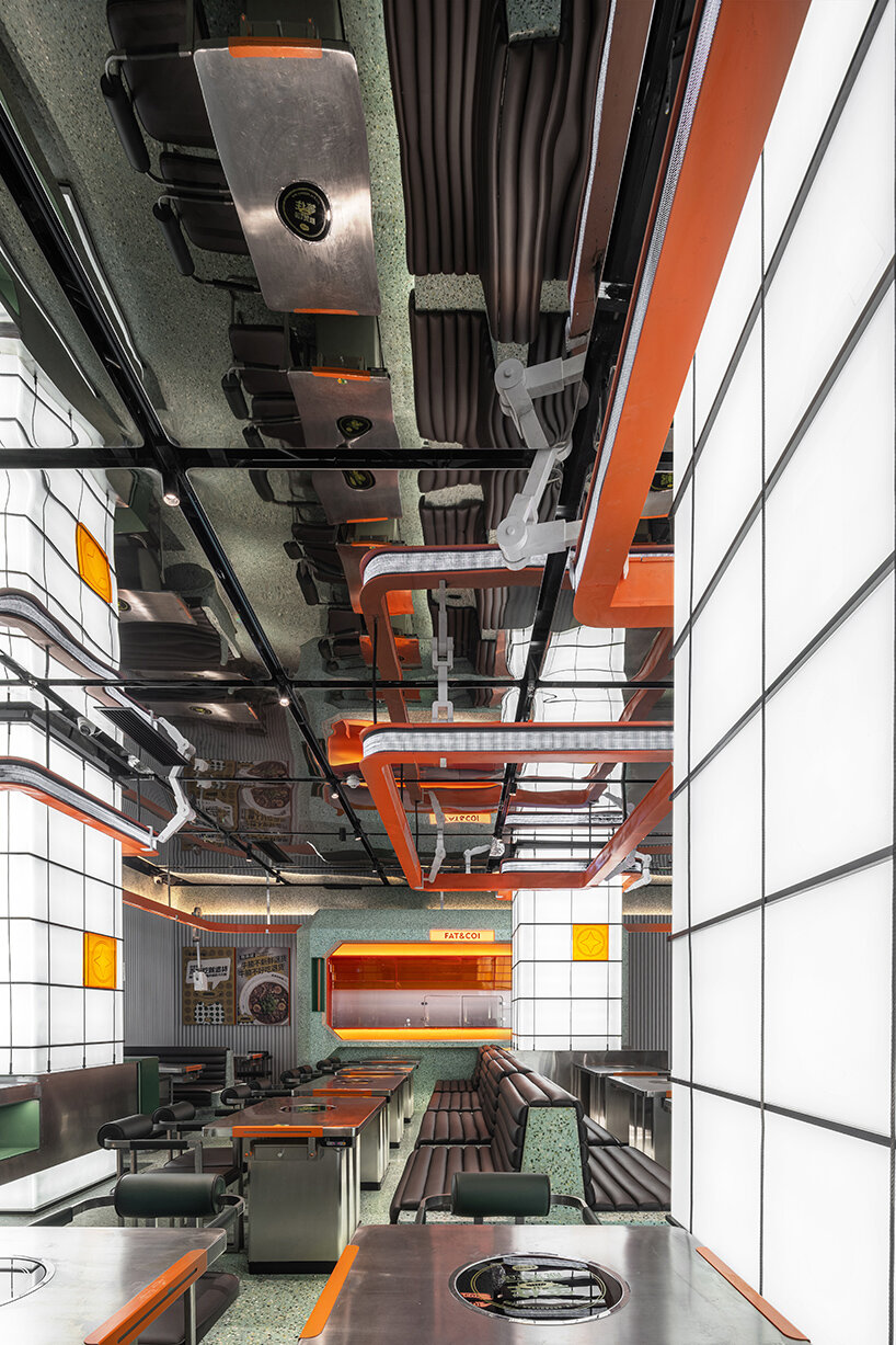 gray-green and bright orange tones collide within this futuristic dining spot in china