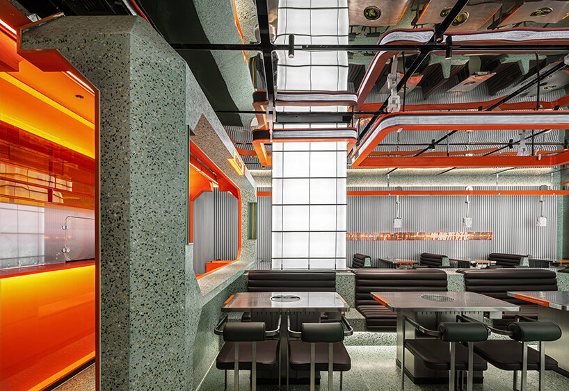 gray-green and bright orange tones collide within this futuristic dining spot in china