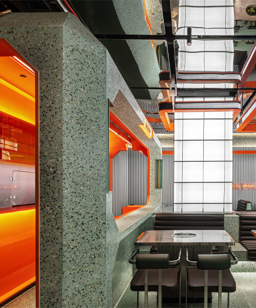 gray-green and bright orange tones collide within this futuristic dining spot in china