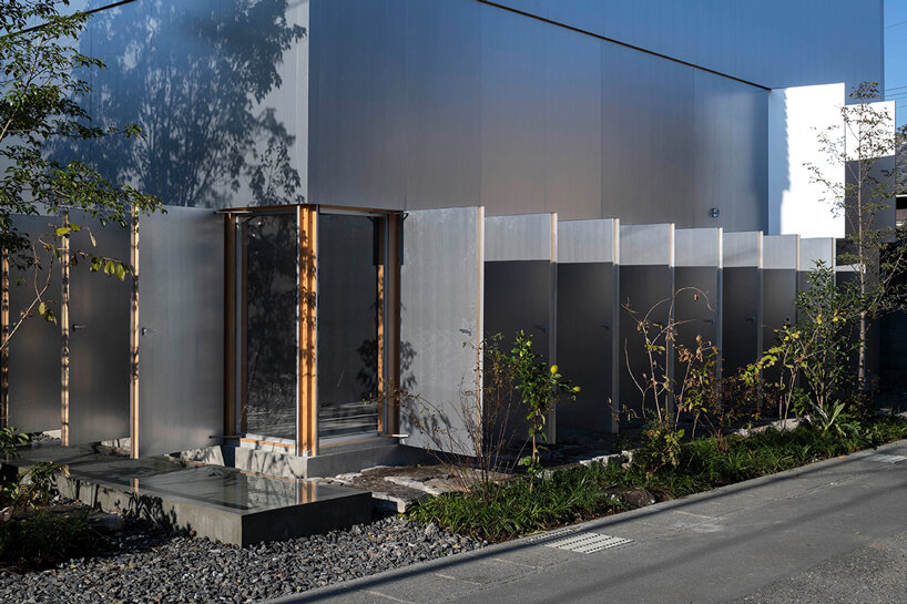 operable silver facade wraps japanese wooden house by seiichi yamada & associates