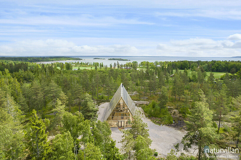 naturvillan is a self-sufficient, off-grid A-frame greenhouse home in sweden