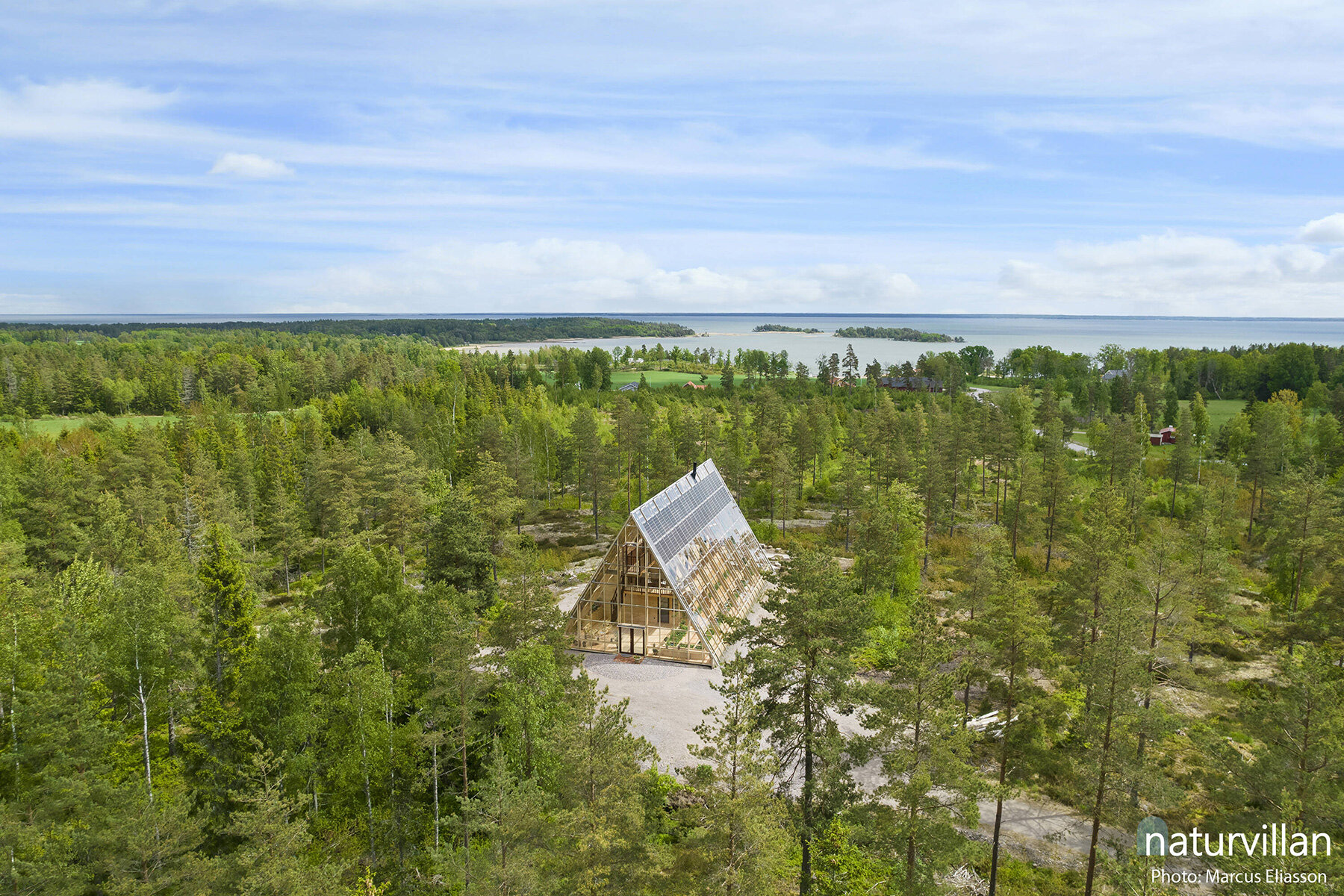 naturvillan is a self-sufficient, off-grid A-frame greenhouse home in sweden