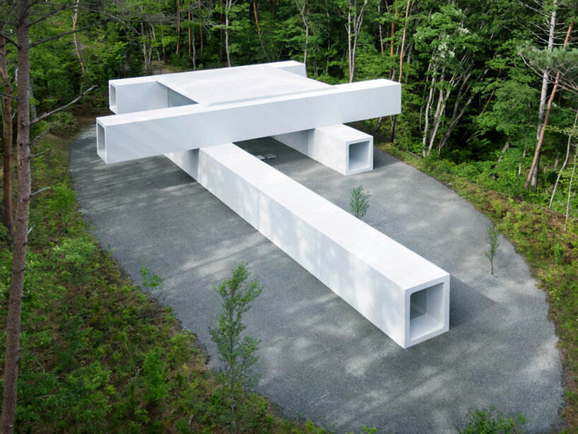 nendo stacks precast concrete culverts to create a minimalist guesthouse in japan