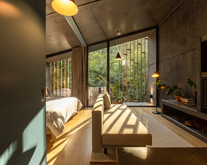 summary architecture scatters tiny hotel cabins over idyllic landscape of paradinha