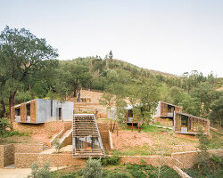 summary architecture scatters tiny hotel cabins over idyllic landscape of paradinha