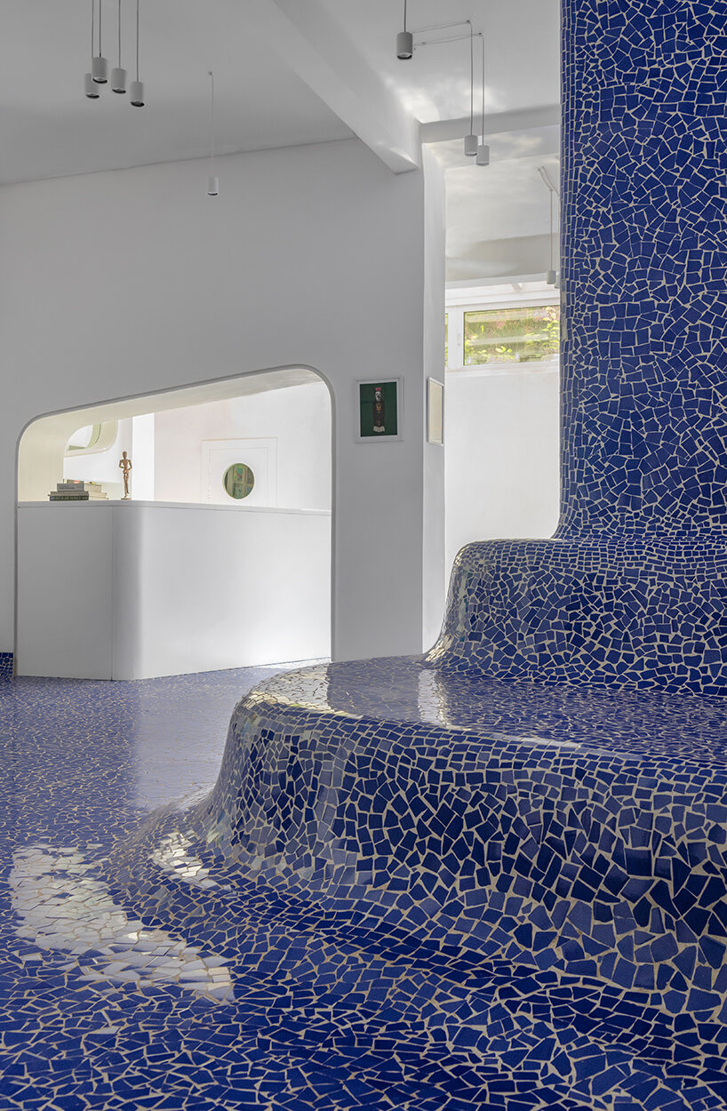 abin design studio sculpts its art rickshaw gallery with 'islands' of undulating blue tilework