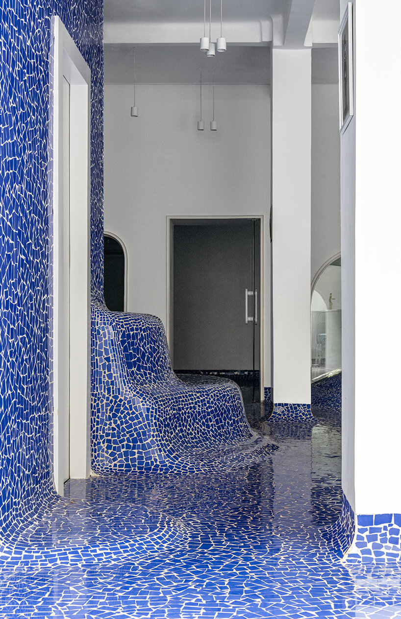 abin design studio sculpts its art rickshaw gallery with 'islands' of undulating blue tilework