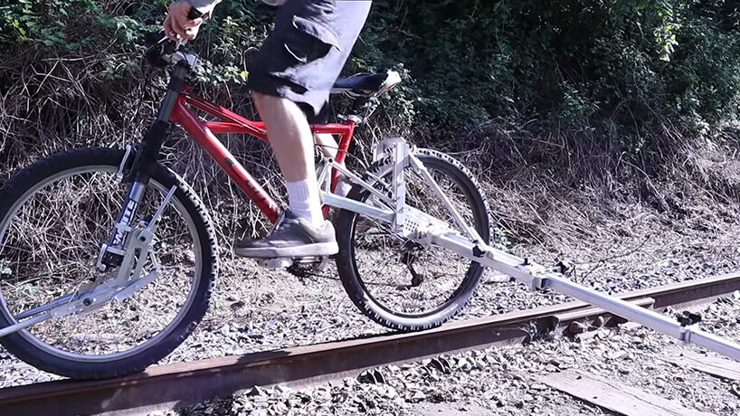 this collapsible accessory turns your bike into a drain to ride on abandoned railroad tracks
