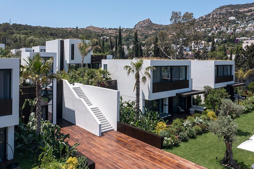 CAJA resort highlights scenic beach in turkey with arrangement of white-washed cubic villas