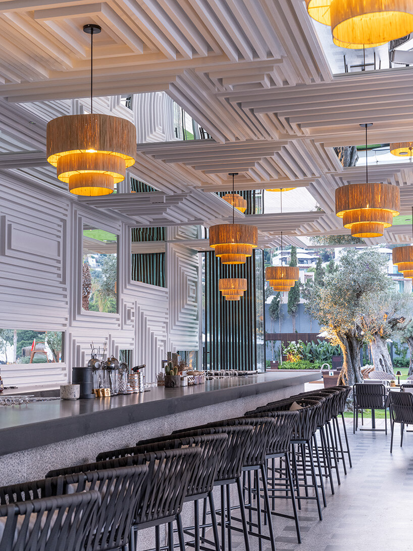 CAJA resort highlights scenic beach in turkey with arrangement of white-washed cubic villas