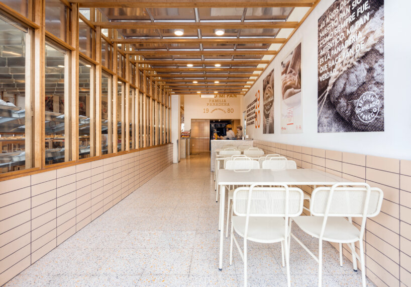 concèntrico envelops mi pan bakery with hanging metallic trays and pinewood in mexico