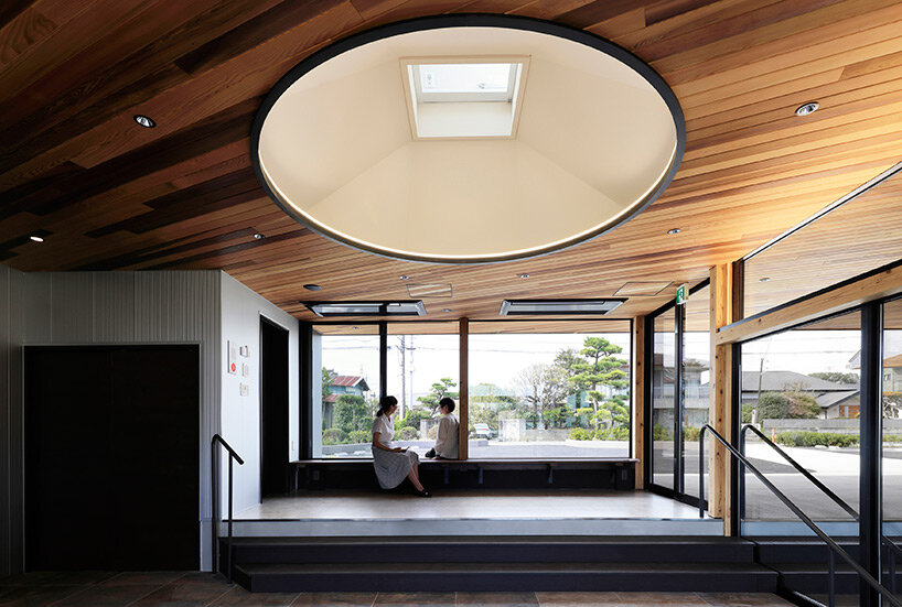 symbolic circular skylight fills sugawaradaisuke's family clinic in japan with natural light