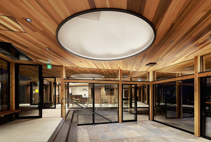 symbolic circular skylight fills sugawaradaisuke's family clinic in japan with natural light