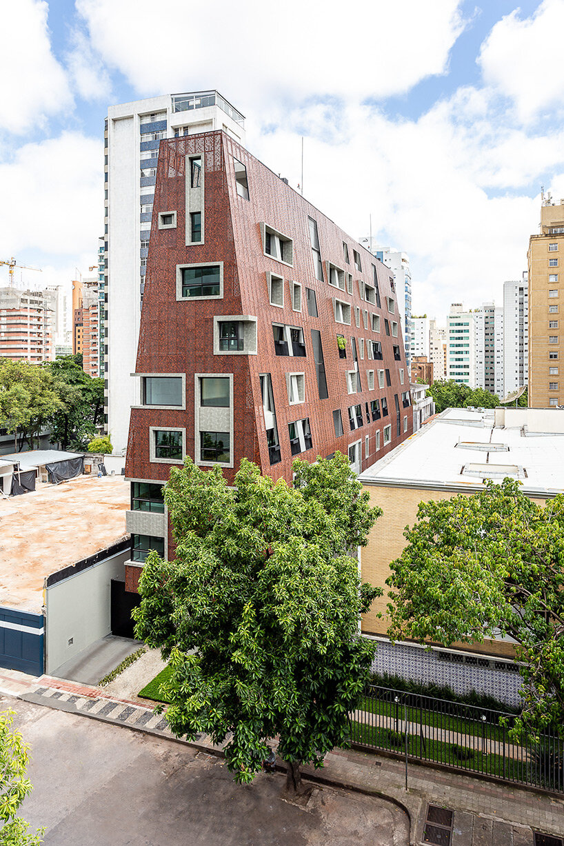 perforated red aluminum skin envelops gisele borges' pyramidal residential building in brazil