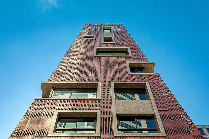 perforated red aluminum skin envelops gisele borges' pyramidal residential building in brazil