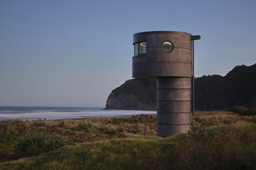 crosson architects perches robust concrete lifeguard tower along tranquil new zealand beach