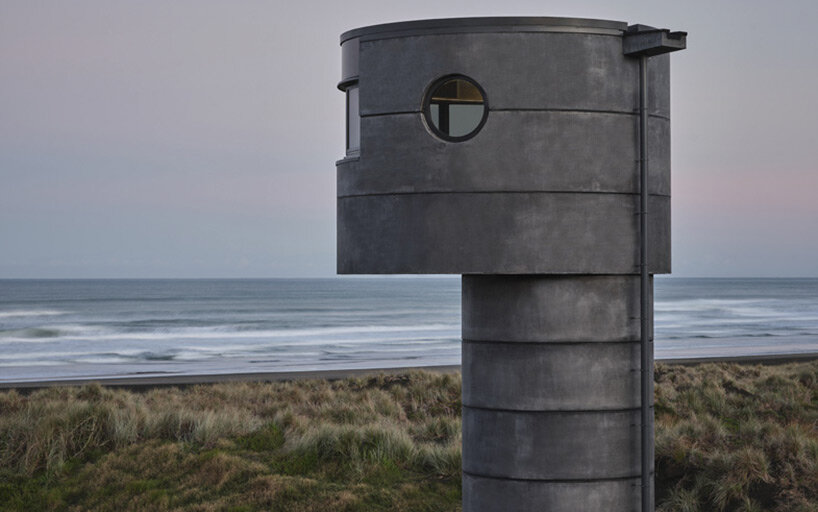 crosson architects perches robust concrete lifeguard tower along tranquil new zealand beach