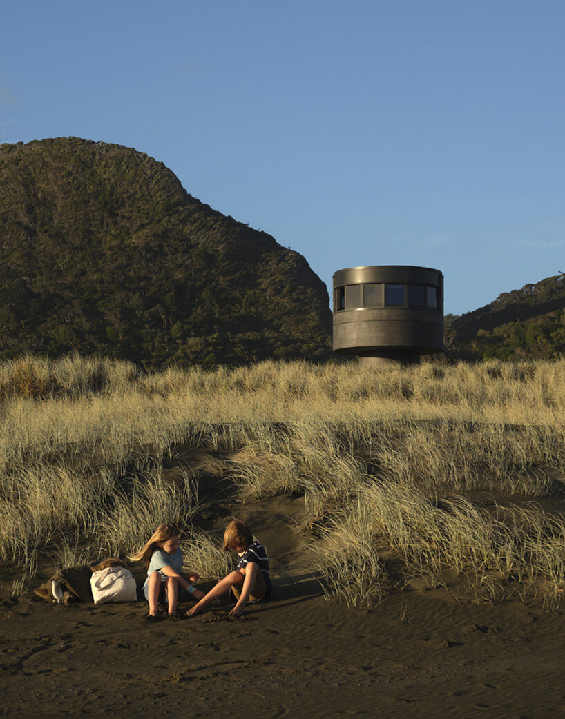 crosson architects perches robust concrete lifeguard tower along tranquil new zealand beach